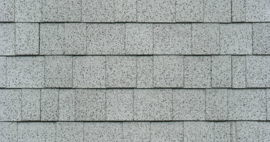 Rows of gray asphalt shingles with a textured surface pattern.