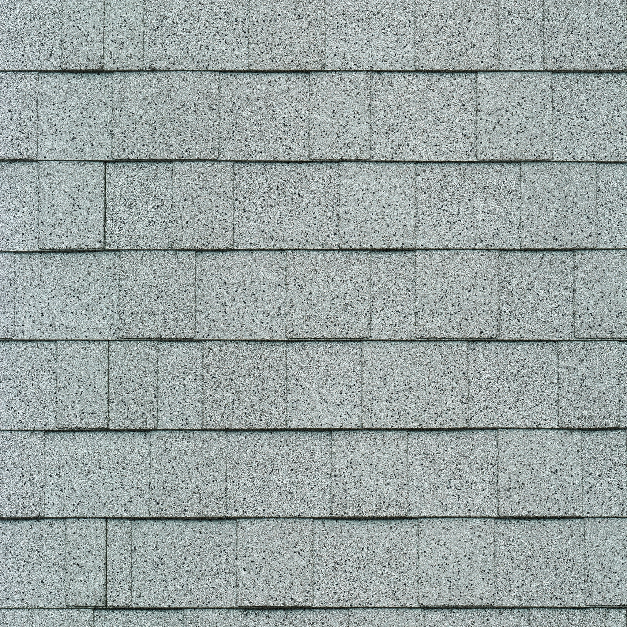 Close-up of Cambridge asphalt roof shingles in a neat, overlapping pattern with hints of Dove White accentuating the gray.